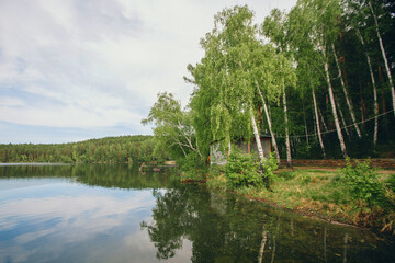 Obraz premium the concept of weather observation, meteorology. wind and small waves. Landscape by the river, trees and sandy beach