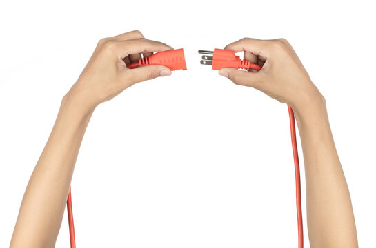Hand holding orange extension cord isolated on white background