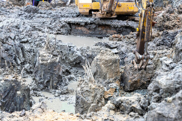 Macco trucks are digging out of pile construction.