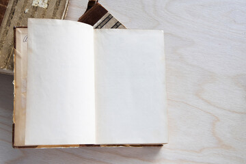 Old vintage book on wooden table. Open book with blank pages