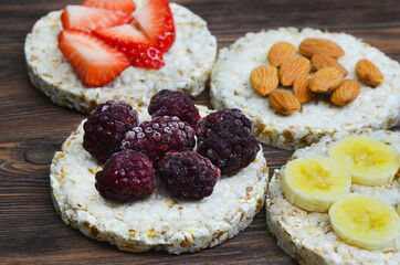 cereal oats food breakfast crisp breads with strawberry, almonds nuts, banana fruit and blackberry, summer healthy eco snack 