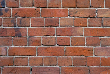 Weathered stained old brick wall background. grange