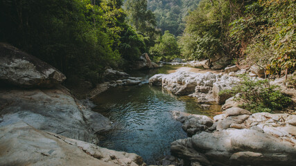 Waterfall in the forest in the middle of the valley.