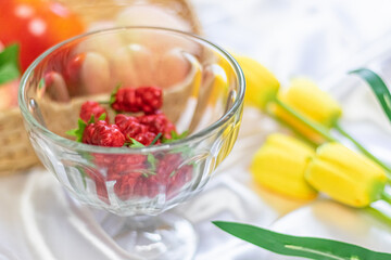 Berry in glass with colorful fruit and flower.