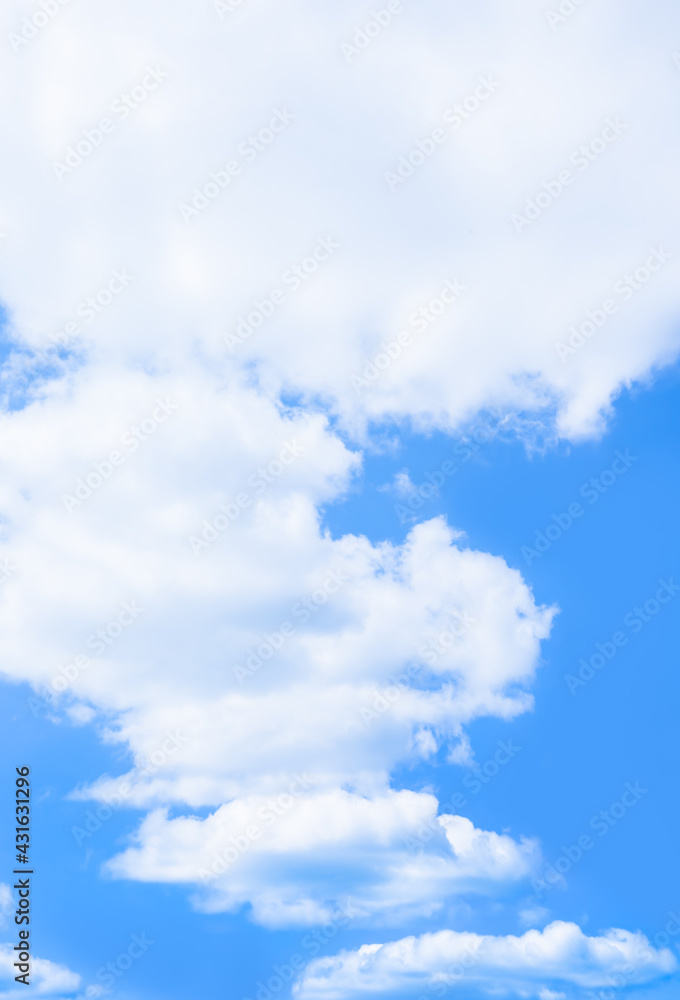 Wall mural soft cumulus clouds floating over bright and clear blue sky on sunny day. pure white cloudscape scen