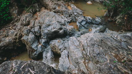Waterfall in the forest in the middle of the valley.