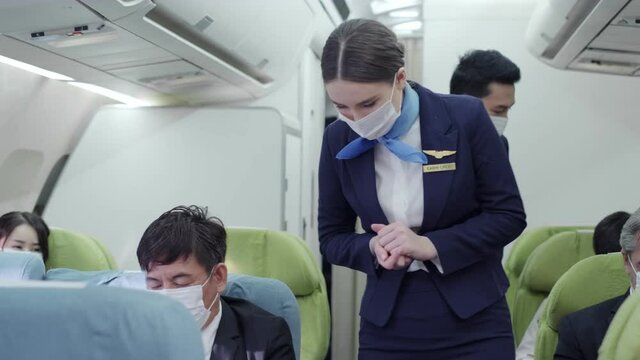 Nice Asian male and beautiful Caucasian female flight attendants in uniform wearing a face mask for protective Covid-19.People wearing mask to prevent virus. 