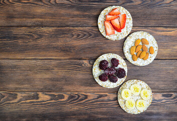 cereal oats food breakfast crisp breads with strawberry, almonds nuts, banana fruit and blackberry, summer healthy eco snack 