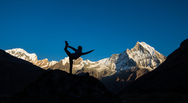 Yoga at sunset, Himilaya mountains, Nepal, Annapurna and Fishtail