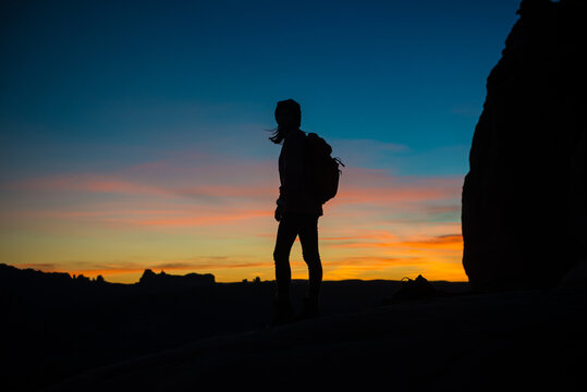 woman looking out in the desert at sunset, moab utah