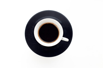 A cup of espresso coffee on an old vinyl record on a white background. Coffee break
