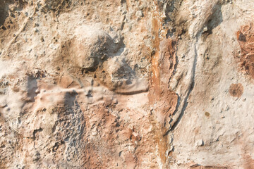 Close-up of abstract background stone cement wall is painted in brown, vintage pattern in brown tones.