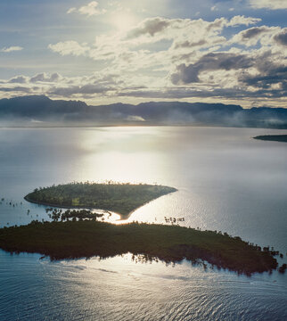 Aerial of a group of small pacific Islands and atolls off Fiji mainland at sunrise