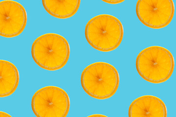 Pattern of circle slices of juicy ripe orange on a blue background. Concept of bright mood
