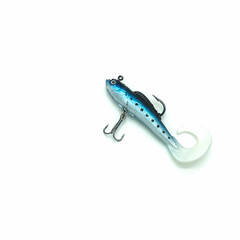 Fishing accessories. The bait is a blue silicone fish with two hooks. The flexible tail is curved. Isolated on a white background. Close-up