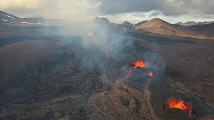 lava eruption volcano with snowy mountains, Aerial view
Hot lava and magma coming out of the crater, April 2021 
