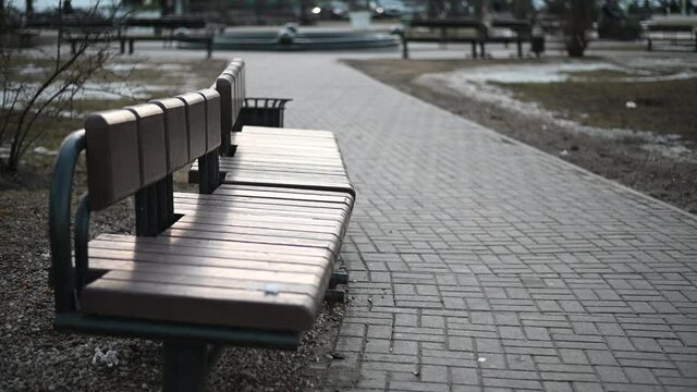 Video of empty bench against city street landscape background