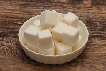 Refined white sugar cubs in the bowl