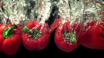 Super slow motion red bell pepper drops water with splashes. Filmed at 1000 fps.On a black background. - Powered by Adobe