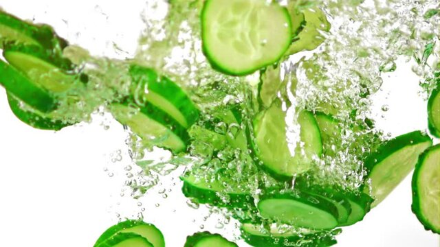 Super slow motion sliced fresh cucumber under water with air bubbles. On a white background.Filmed on a high-speed camera at 1000 fps. High quality FullHD footage