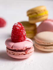 colorful macaroons with raspberries on top