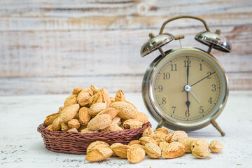 Delicious almonds nut with shell on wood background
