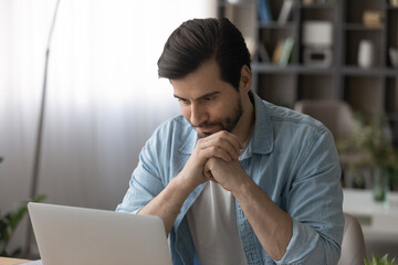 Close up irritated confused businessman looking at laptop screen, having problem with broken or...