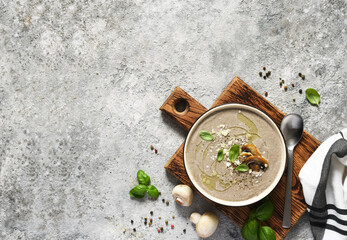 Soup puree with mushrooms and parmesan on a concrete kitchen table.Top view.