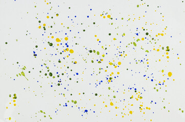 Chaotic drops of paint on white.
