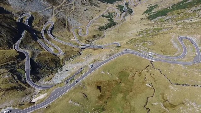 The famous high altitude alpine road named Transfagarasan crossing the Fagaras Mountains , in Transylvania , part of the Carpathian range, a favorite tourist and travel destination , aerial drone foot