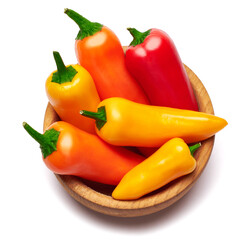 Wooden bowl full of Chili or sweet peppers isolated on white background