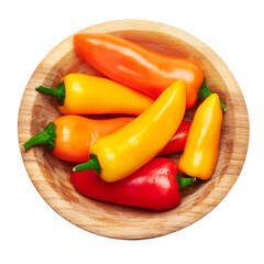 Wooden bowl full of Chili or sweet peppers isolated on white background