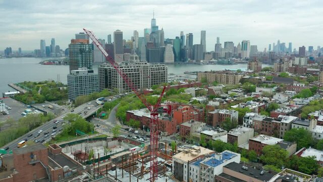 flying over construction crane in Brooklyn towards view of downtown NYC