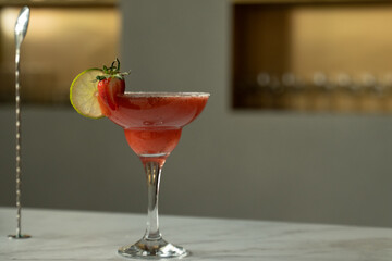 A margarita cocktail sits on the bar counter