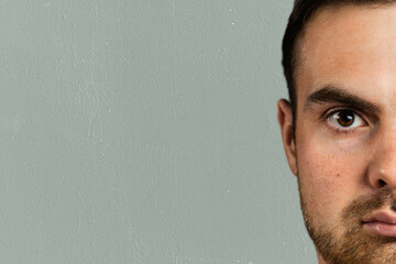 Face of bearded caucasian man lookin to camera. Half of face, copy space