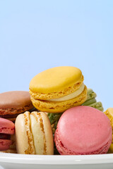 French dessert macaron isolated on blue background. Modern Macarons on colorful background. copy space.