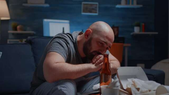 Sad depressed man crying feeling loneliness, chronic fatigue upset tired sick ill suffering from migraine anxiety. Stressed unhealthy lonely person having migraine, bipolar disorder, major depression