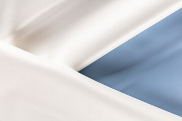 draped surface of artificial leather for sewing clothes in a delicate blue color