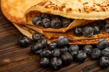 Fresh blueberries and traditional Russian pancakes. Shrovetide week of the end of winter.