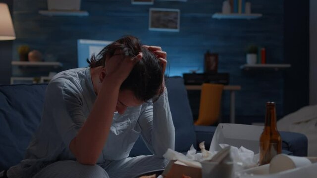 Close up exhausted frustrated depressed young woman massaging temples having mental problems. Stressed unhealthy lonely person feeling tired suffering from migraine, bipolar disorder, major depression