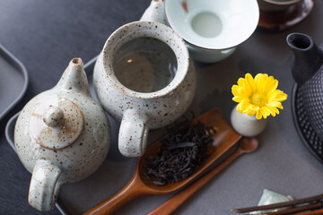Obraz na płótnie Canvas Asian food background with a tea set, cups, tea leaves, and teapot.