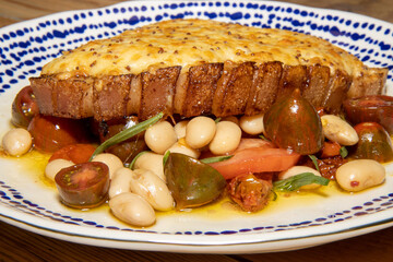 A delicious plate of a Rarebit pork chop with summer bean salad