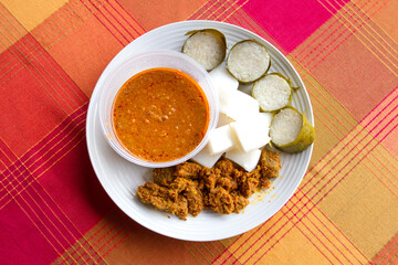Lemang, Ketupat, rendang and curry sauce on plate.