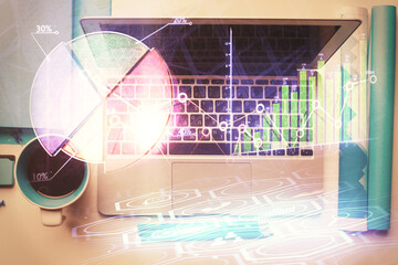 Double exposure of forex graph drawing over desktop background with computer. Concept of financial analysis. Top view.