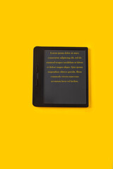 Modern e reader  on bright yellow background for reding concept. Mockup digital with exa[le text.