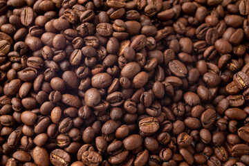 Texture of dark coffee beans. Coffee beans background. Roasted coffee full frame.