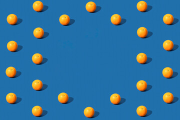 Orange fruit pattern on blue background. Space for text. Copy space.