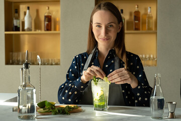 Bartender preparing mojito cocktail served in restaurant bar
