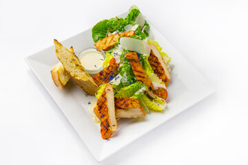 Caesar salad on white plate