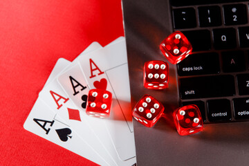 Online poker casino theme. Playing cards and dices on a red background